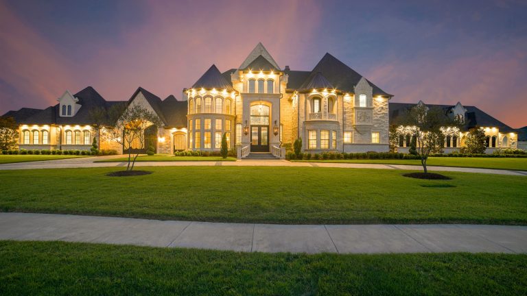 Upscale family home lit at twilight