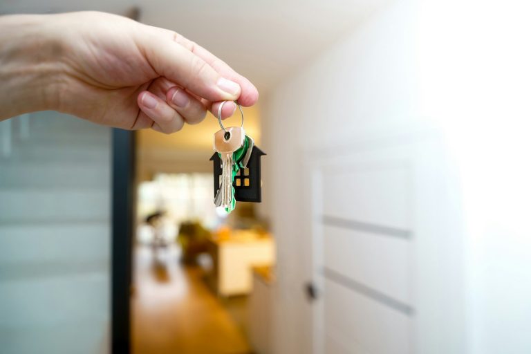 New homeowner holding house keys at the front door